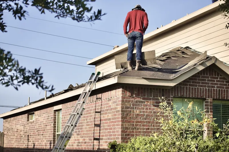 Professional roofer working on a residential roof in Sweet Farms